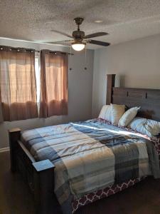 a bedroom with a bed and a ceiling fan at Bi-Level Suite in Saskatoon in Saskatoon