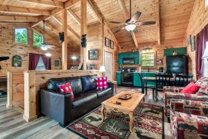 a living room and kitchen in a log cabin at A Top Notch Lodge~Gatlinburg in Gatlinburg
