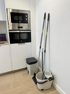 a kitchen with a microwave oven and mop at CASTILLA LUXURY B Apartments in Madrid
