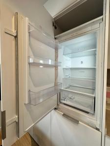 an empty refrigerator with its door open at Castilla Luxury 2B Apartment in Madrid
