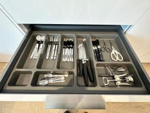 a tray filled with utensils in a drawer at Castilla Luxury 2B Apartment in Madrid