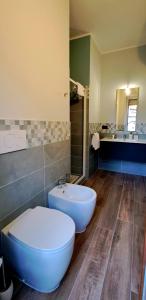 a bathroom with a toilet and a sink at MarTina's Home GRIS in Alba