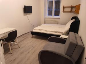 a room with two beds and a desk and a chair at Apart Comfort in Prague