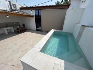 a swimming pool on the side of a house at CASA ALKAPEPE in Ontur