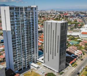 an aerial view of two tall buildings in a city at 0201 iFreses Hermoso Apartamento Full Equipado SIN PARQUEO in Curridabat