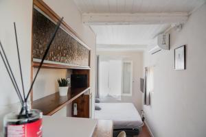 Habitación pequeña con cama y nevera. en Torre al Serraglio en Prato