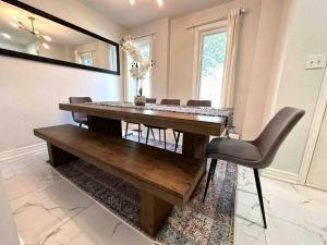 a dining room with a wooden table and chairs at Charming Home in Prime Location North of Toronto in Richmond Hill