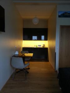 a living room with a table and a kitchen at Skýjaborg Studios in Höfn +21 photos