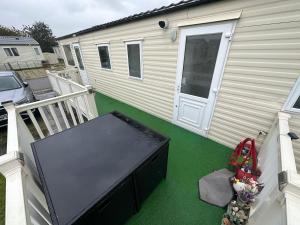 a screened in porch of a house with a large pool at Robin Hood Rhyl caravan oaklands in Rhyl