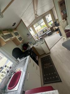 an overhead view of a kitchen with a sink and a stove at Robin Hood Rhyl caravan oaklands in Rhyl