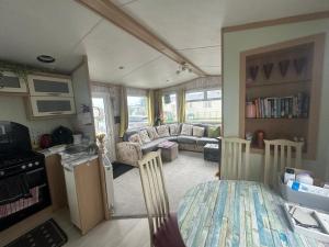 a living room with a couch and a table at Robin Hood Rhyl caravan oaklands in Rhyl