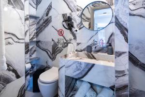 a bathroom with a toilet and a sink and a mirror at Vassilia on the beach Serifos in Livadakia