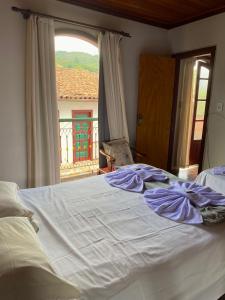 Ein Bett oder Betten in einem Zimmer der Unterkunft Casa do Alferes