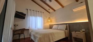 a bedroom with a bed and a table and a chair at Vista Coiba Villas & Restaurant in Santa Catalina
