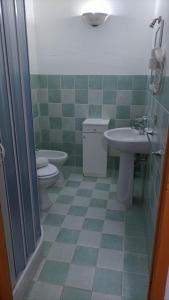 a bathroom with a toilet and a sink at B&B Rena Majore con piscina privata! in Rena Majore +18 photos