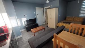 a living room with a couch and a bed at Modern Studio Maidstone - Redecorated Oct 2023 in Maidstone