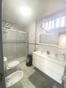 a bathroom with a sink and a toilet and a shower at Ocean Park 7th floor sea and pool view in Adeje