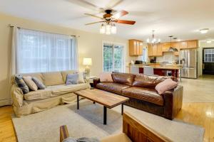 a living room with a couch and a table at Lakefront Homer Abode with Patio and Backyard! in Homer