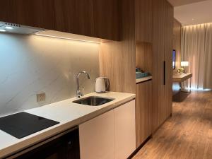 a kitchen with a sink and a counter top at Căn hộ khách sạn Alacarte Hạ Long in Ha Long