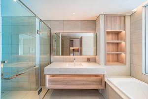 a bathroom with a sink and a glass shower at Căn hộ khách sạn Alacarte Hạ Long in Ha Long +32 photos