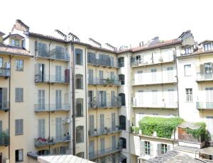 an apartment building with plants on the balconies at ROSSO MAGENTA - Luminoso loft in centro e a due passi dalla stazione in Turin
