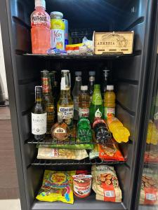 a refrigerator filled with lots of food and drinks at Lux Plaza Hotel in Arbatʼ