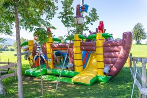 a colorful inflatable playground in a park at Familienhotel Löwen in Nesselwang