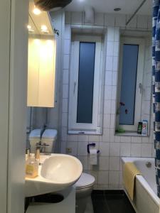 La salle de bains est pourvue d'un lavabo, de toilettes et d'un miroir. dans l'établissement Schönes Zimmer 1 Etage inkl Parkplatz nach Verfügbarkeit, à Essen