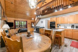 a kitchen and dining room with a wooden table and chairs at Eagle's Nest in Little Cove
