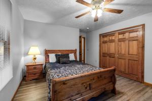 a bedroom with a bed and a ceiling fan at Eagle's Nest in Little Cove