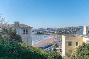 a view of the beach from a building at Stunning Sea View Central Torbay Home with Parking in Torquay