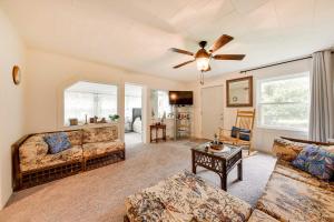 a living room with two couches and a ceiling fan at Powers Lake Home with Patio - 9 Mi to Lake Geneva! in Powers Lake