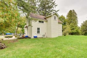 a white house with a yard at Powers Lake Home with Patio - 9 Mi to Lake Geneva! in Powers Lake