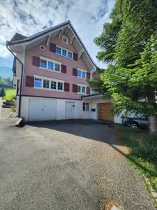 a large pink house with a garage at Cosy Family House in Alt Sankt Johann