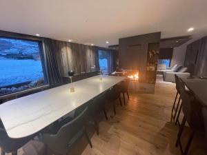 a large white table in a room with a large window at Chalet Esquinade 4 bedrooms appartment Megève in Megève