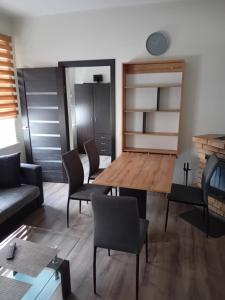 a living room with a table and chairs at ML place in Liepāja