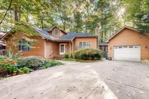 a wooden house with a driveway and a garage at Beaconhill Road 68 in Ocean Pines