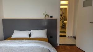 a bedroom with a bed with two pillows on it at Dokki I Madina Apt I 2min to Nile in Cairo