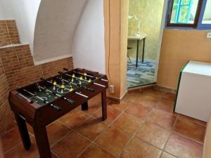 a game table in a room with a brick wall at Casa con terraza a 10min de la playa in Cullera