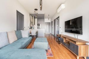 a living room with a couch and a flat screen tv at Benesta Taksim No.8 in Istanbul