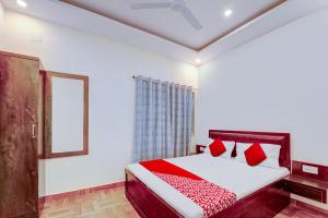 een slaapkamer met een bed en een spiegel bij Flagship Hotel Days Inn in Rānchī