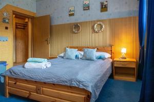 a bedroom with a large bed with two pillows at PROMYK - Apartamenty & Pokoje - dla dorosłych in Białogóra
