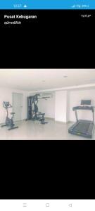 a picture of a gym with two exercise bikes at Studio Healing Sayana Apartment in Tambun-lobangbuaja