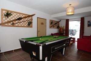 a living room with a pool table in it at Appartement sur les pistes de ski avec piscine in Sainte-Marie-de-Vars