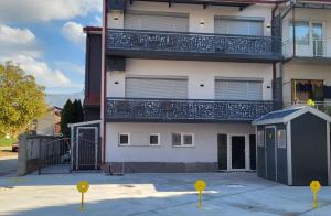 a building with a balcony on the side of it at Enjoy Apartments Prilep in Prilep