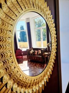 a mirror reflecting a living room with a couch at The Hamilton Luxury Let-The Duke in Scorton