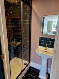 a bathroom with a sink and a glass shower at The Hamilton Luxury Let-The Duke in Scorton