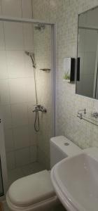 a bathroom with a shower and a toilet and a sink at casa alcindo in Portela