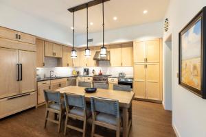 a large kitchen with a wooden table and chairs at The Blake Residences in Taos Ski Valley