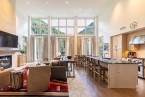 a large kitchen and living room with a large window at The Blake Residences in Taos Ski Valley